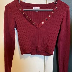Deep red cropped ribbed sweater with lace-up holes
